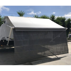 A rv parked in a parking lot with a 3.35m Caravan Privacy Shade Screen For 3.5m Fiamma Box Awning.