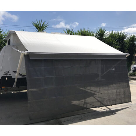 A 3.85m caravan privacy shade screen for 4.0m Fiamma box awning parked in a parking lot with a awning.