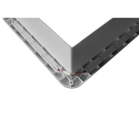 A white plastic frame with a TRA LED light Garnish with built-in Switch attached to it.